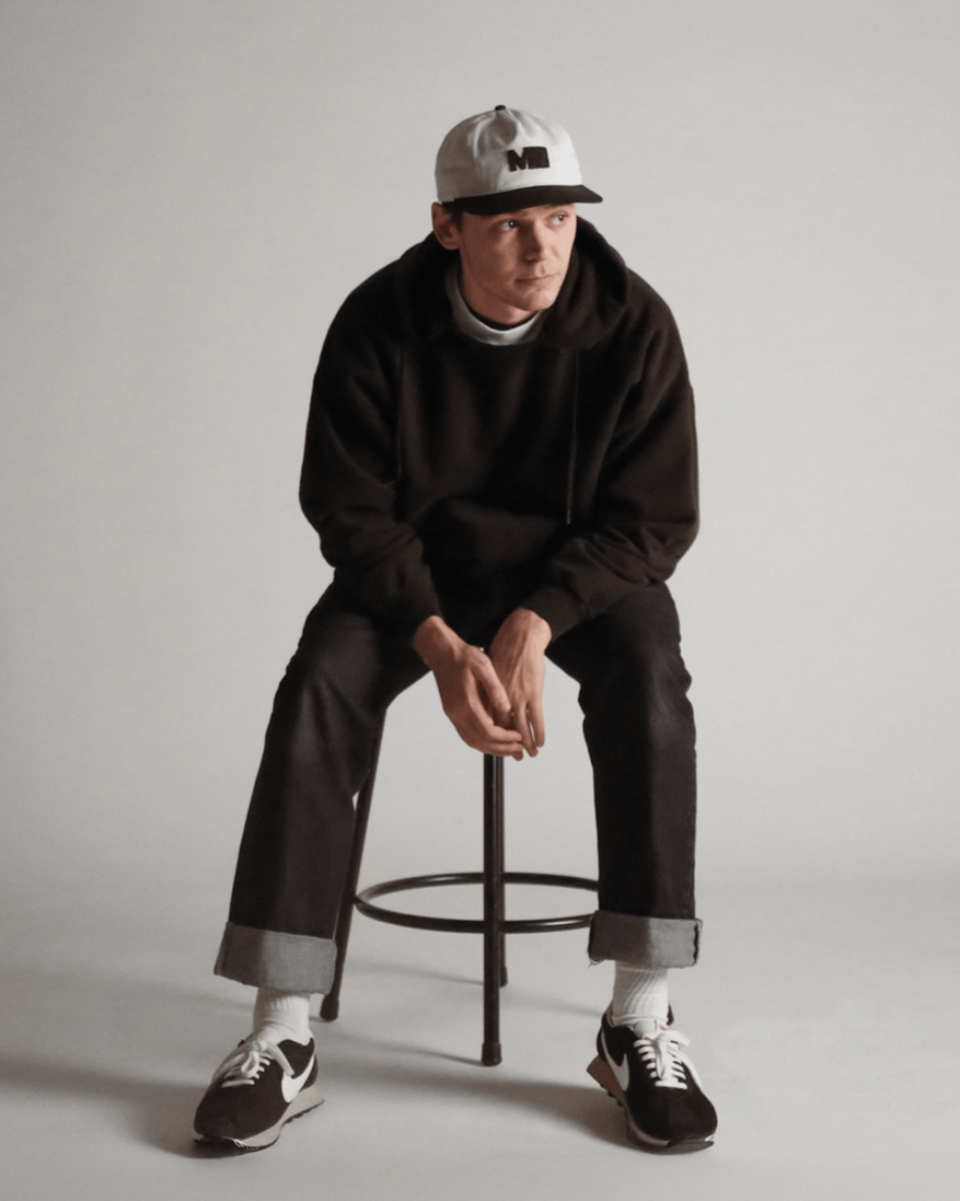 Hayden Jarvis, founder of Midwest, seated on a stool